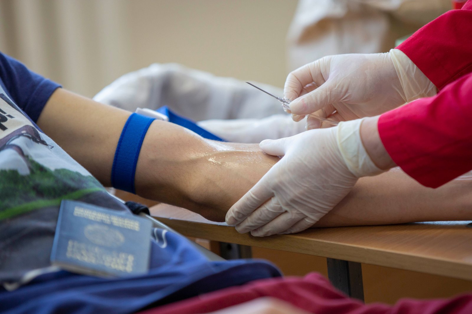 Phlebotomist following strict hygiene protocol during sample collection